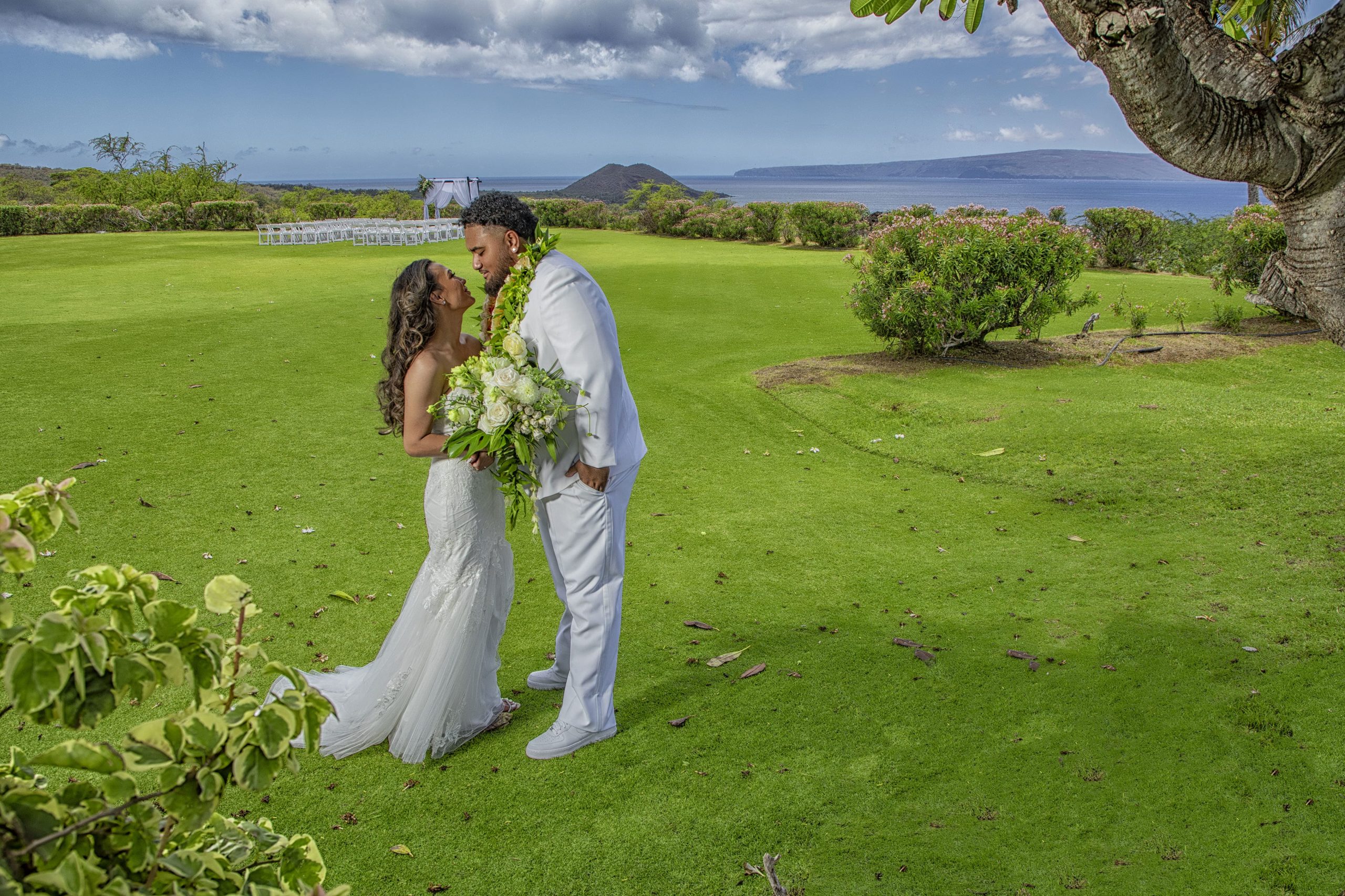Bride and groom sharing a romantic moment outdoors.