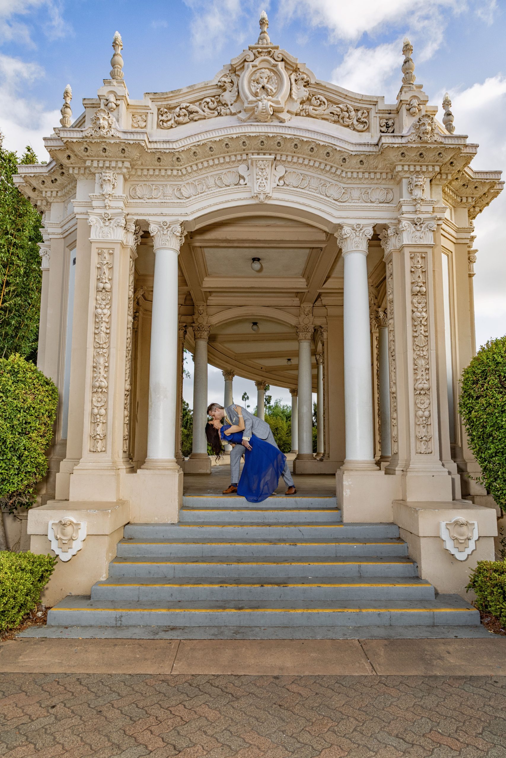 Couple embracing near ornate architectural structure