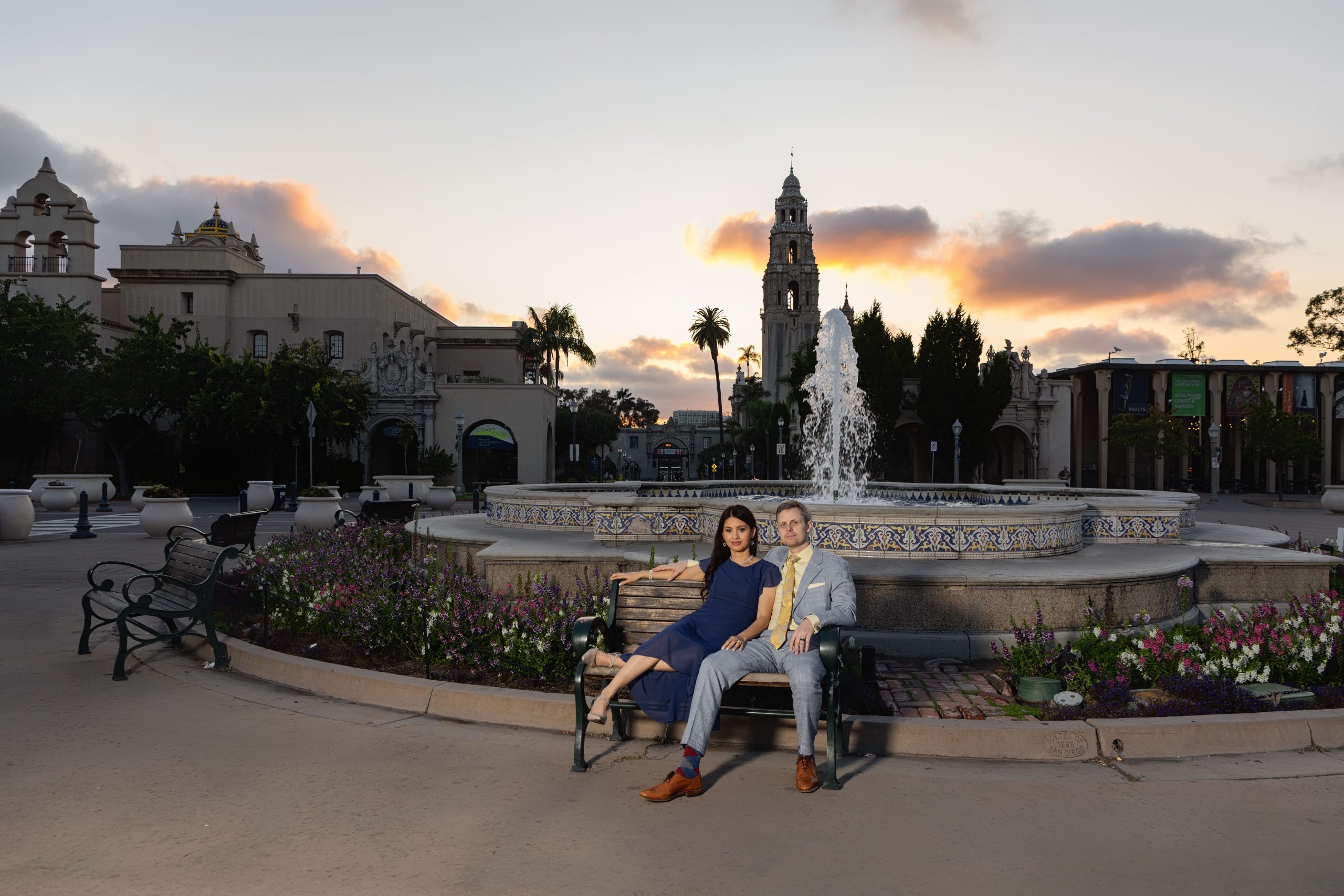 Couple sitting by a fountain at sunset