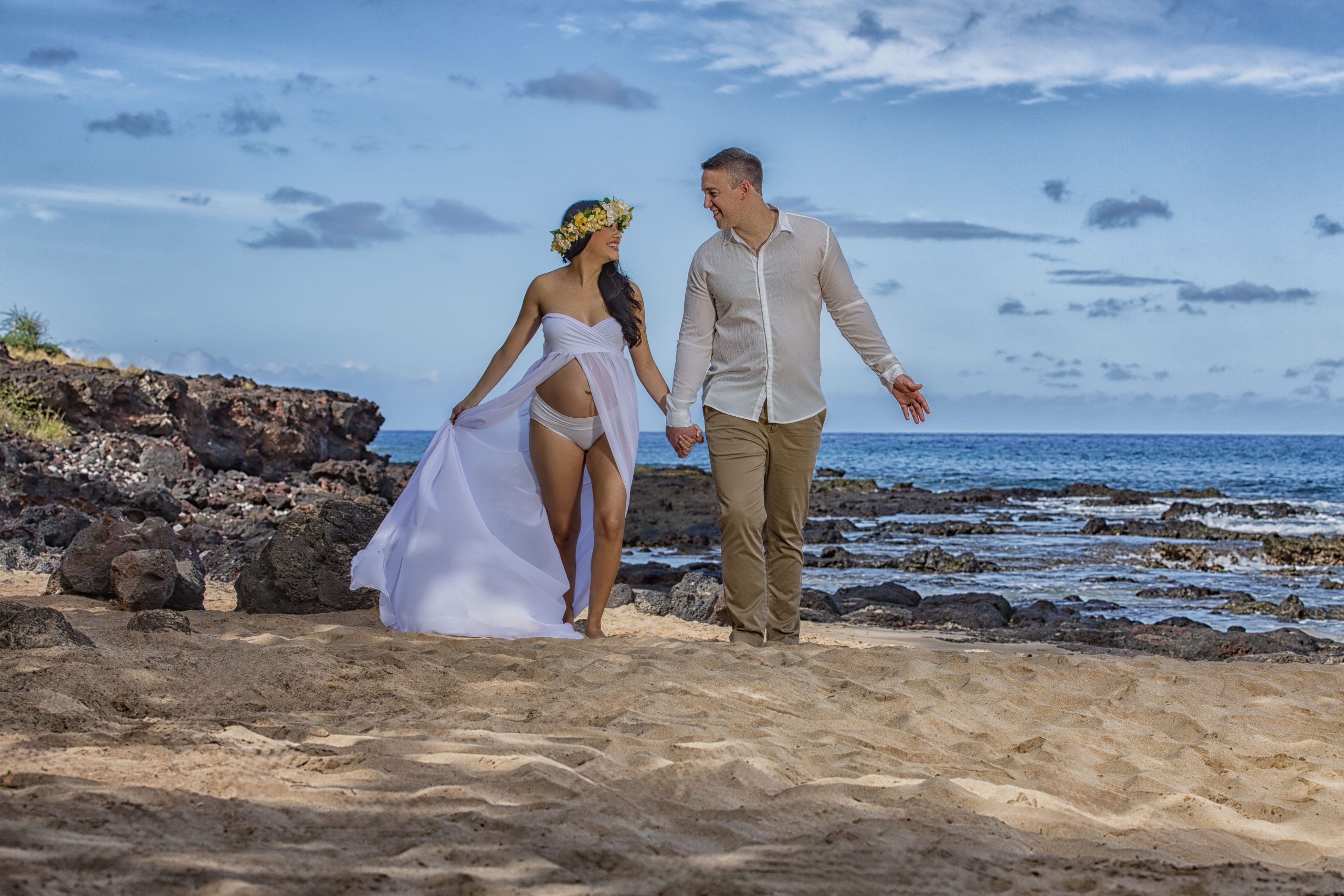 Couple walking on beach, enjoying their time together.