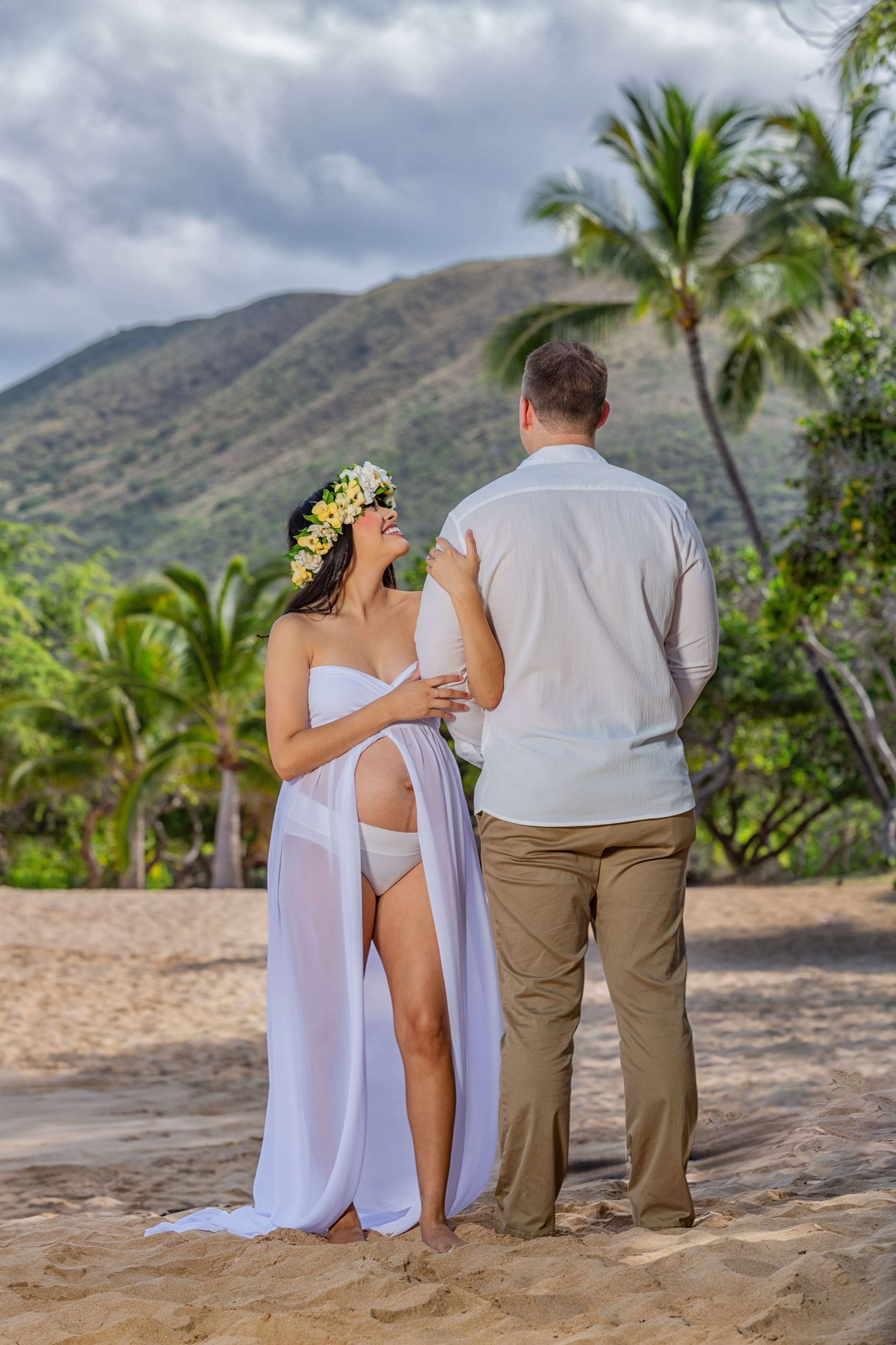 Pregnant couple enjoying a beach moment