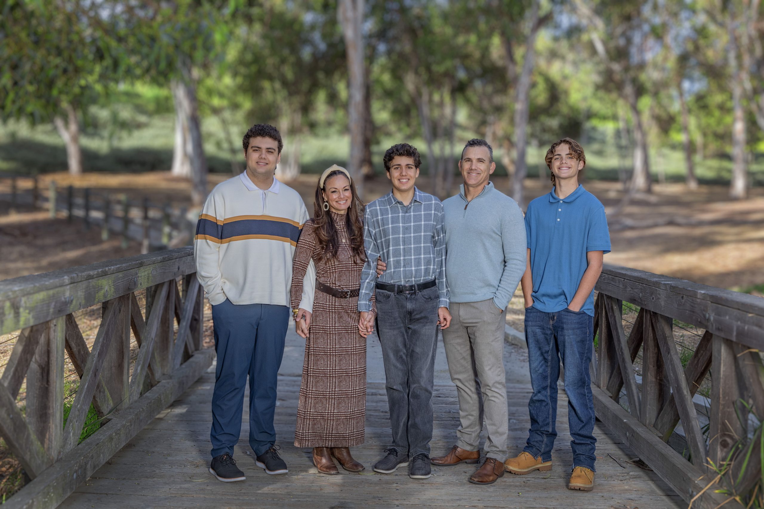 Group portrait of a family on a bridge.