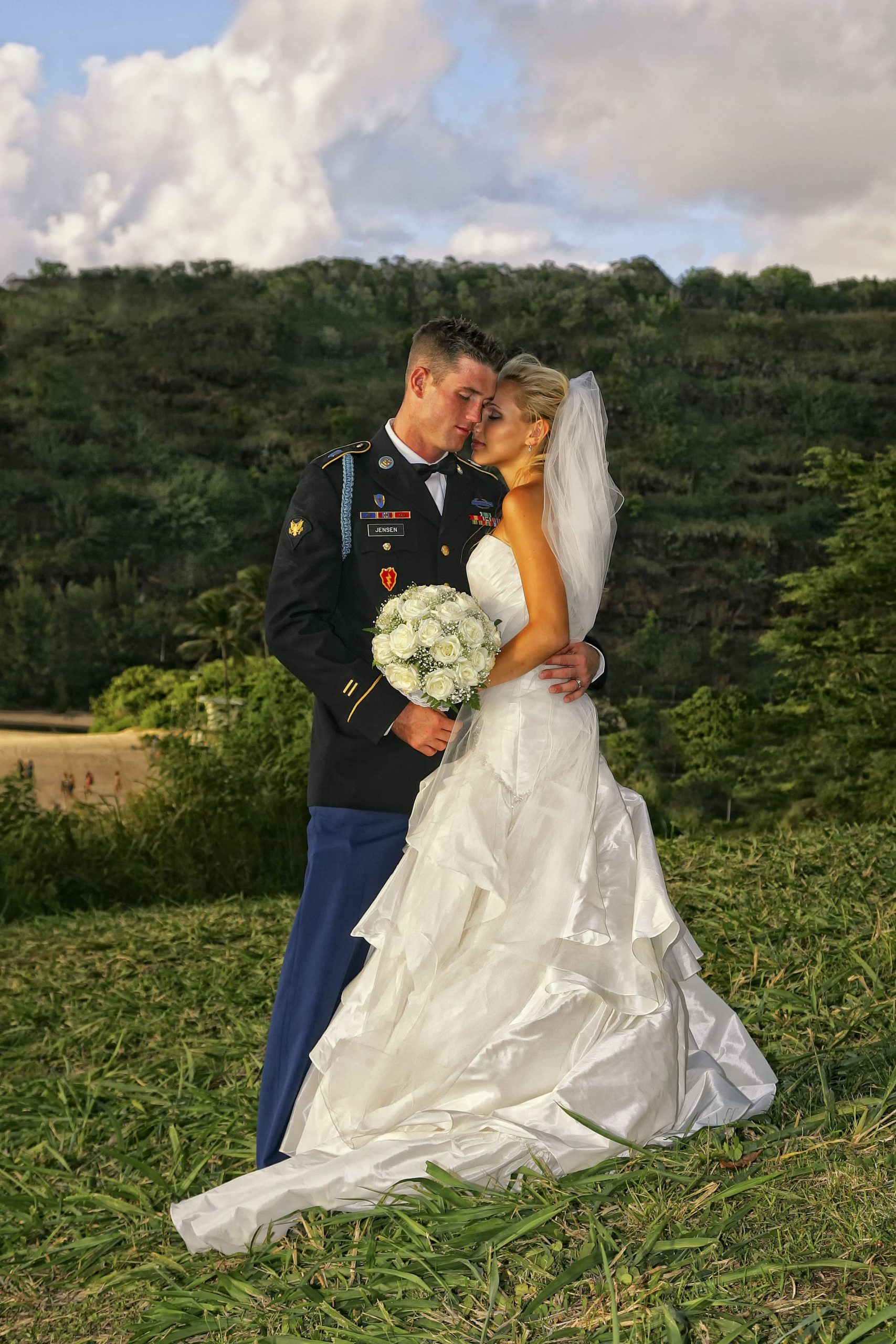 Bride and groom sharing a romantic moment outdoors.