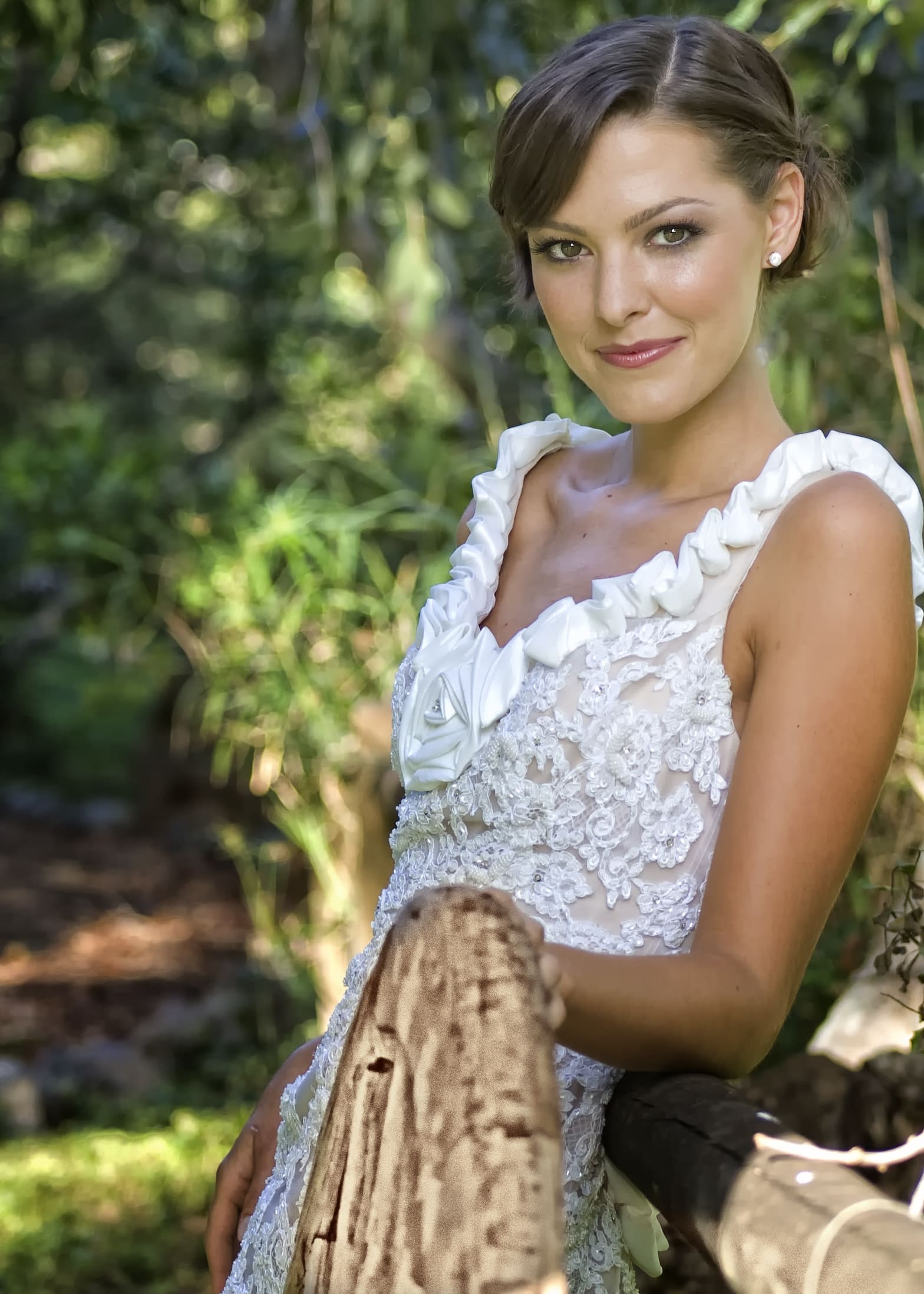 Bride posing elegantly in a natural setting.